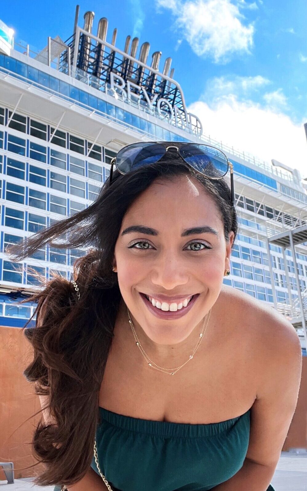 close up of person smiling with celebrity beyond ship behind them