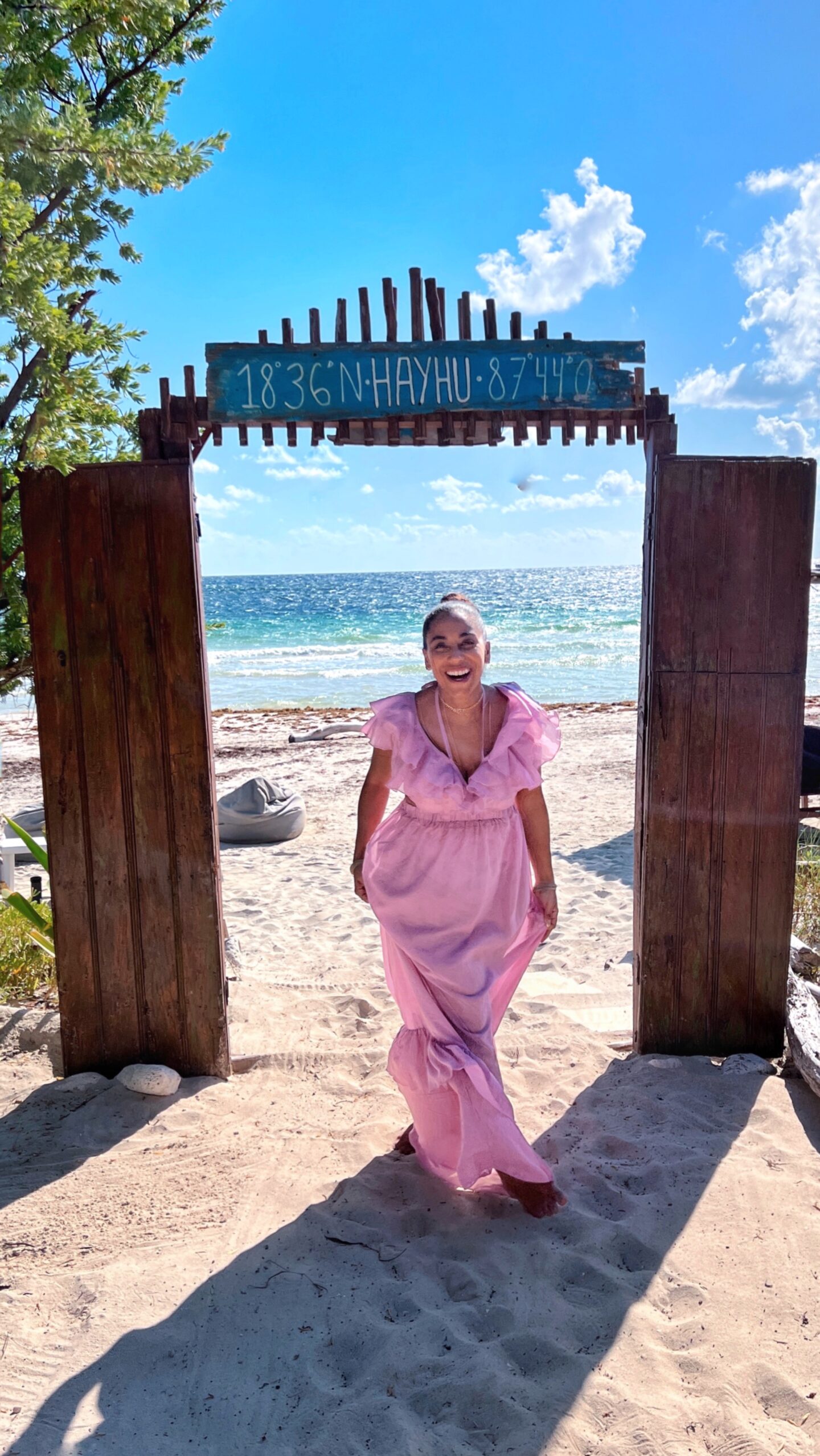 person in pink dress on beach